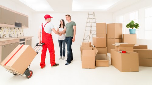 Worker using safe manual handling techniques with storage items